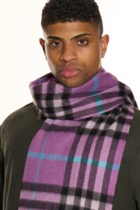 A professional styling shot of an oversized cashmere stole worn as a wrap, perfect for international festival travel.