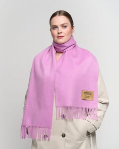 A close-up of the delicate work on a charcoal cashmere scarf, showing the density of the 140g weave.