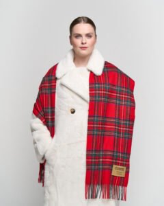 A close-up of an iconic red tartan cashmere scarf, symbolising prosperity and Scottish tradition.